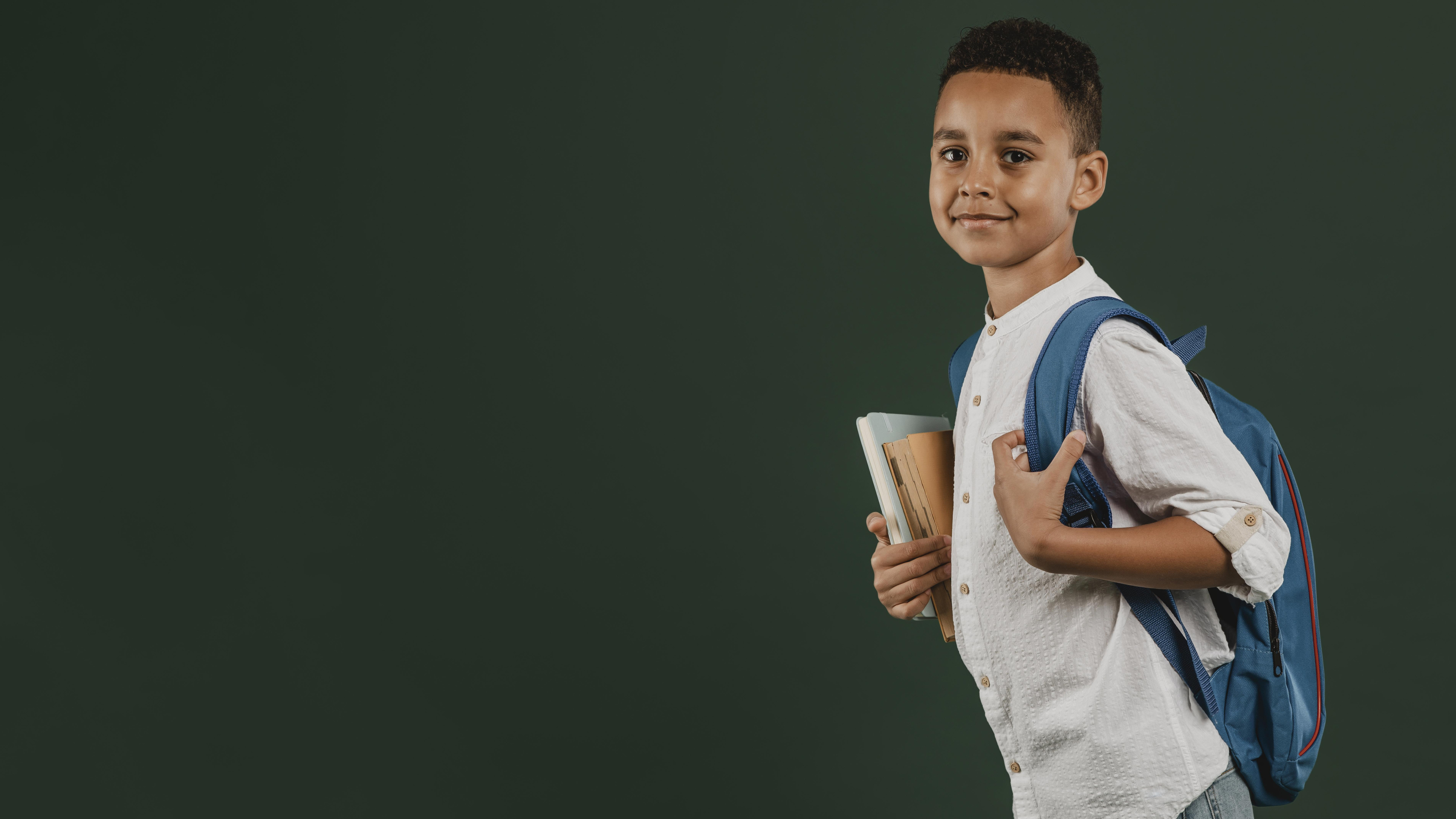 Student with backpack and books in a modern Kenyan school